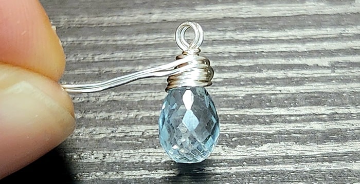 Behind the Wrap Newsletter shows the process of wire-wrapping aquamarine gemstone