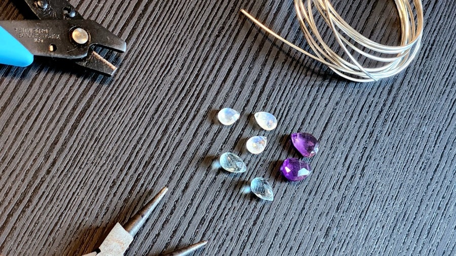 Natural amethyst, moonstone, and aquamarine stones with sterling silver wire and pliers for wire wrapping