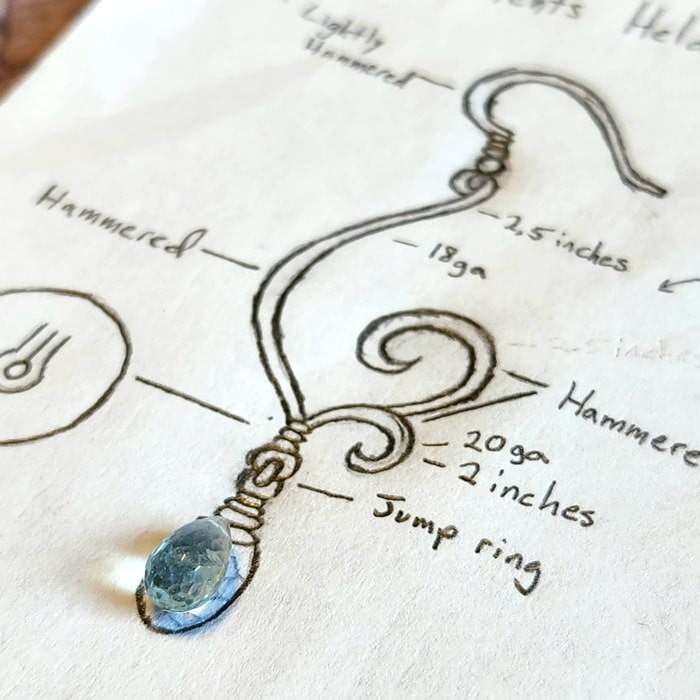 Nature-inspired jewelry design sketch with aquamarine stone
