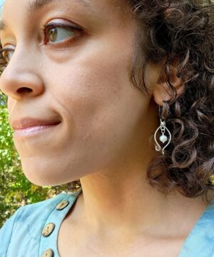 Freshwater pearl earrings worn under natural light