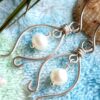 Handmade sterling silver freshwater pearl earrings on blue blanket