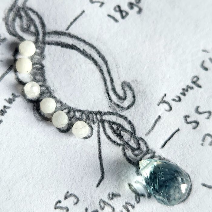 Low Tide jewelry design sketch with wire-wrapped rainbow moonstone and aquamarine gemstones