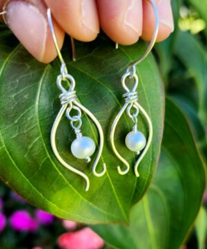 Ocean-inspired handmade sterling silver freshwater pearl earrings on leaf