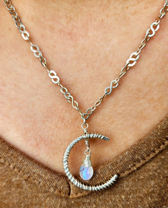 Handmade moonstone jewelry pendant in sterling silver, worn