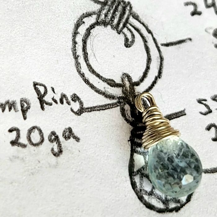 Ocean gemstone jewelry design sketch closeup with wire-wrapped aquamarine gemstone on top