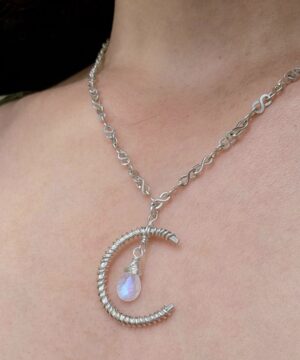 Wearing sterling silver crescent moon pendant indoors