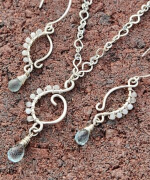 Coastal-inspired gemstone jewelry set on stone