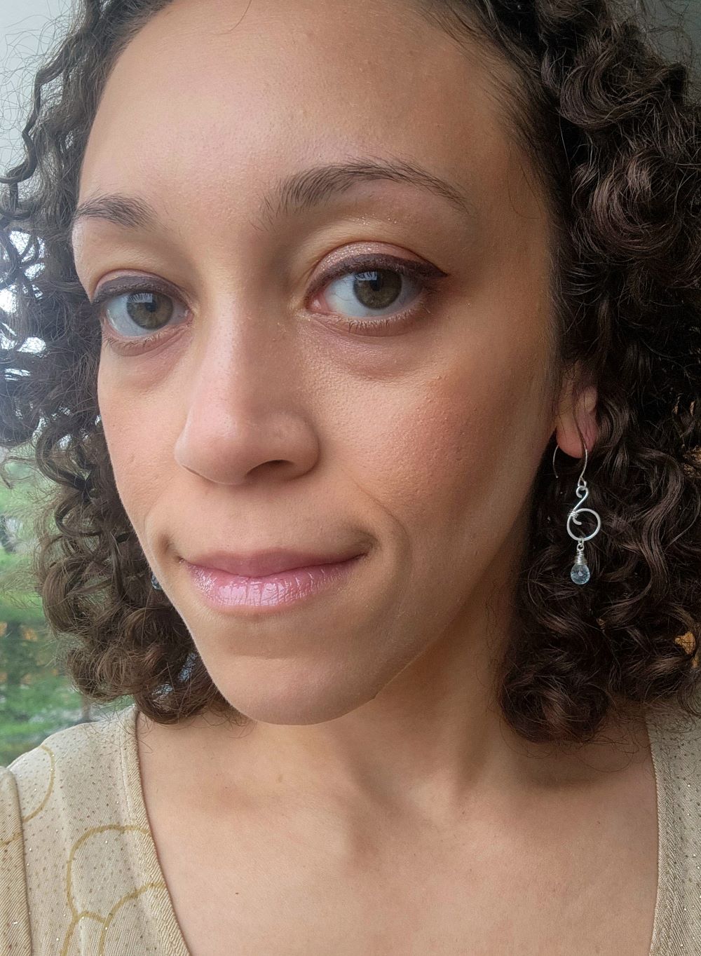 Handcrafted sterling silver ocean inspired aquamarine earrings worn indoors