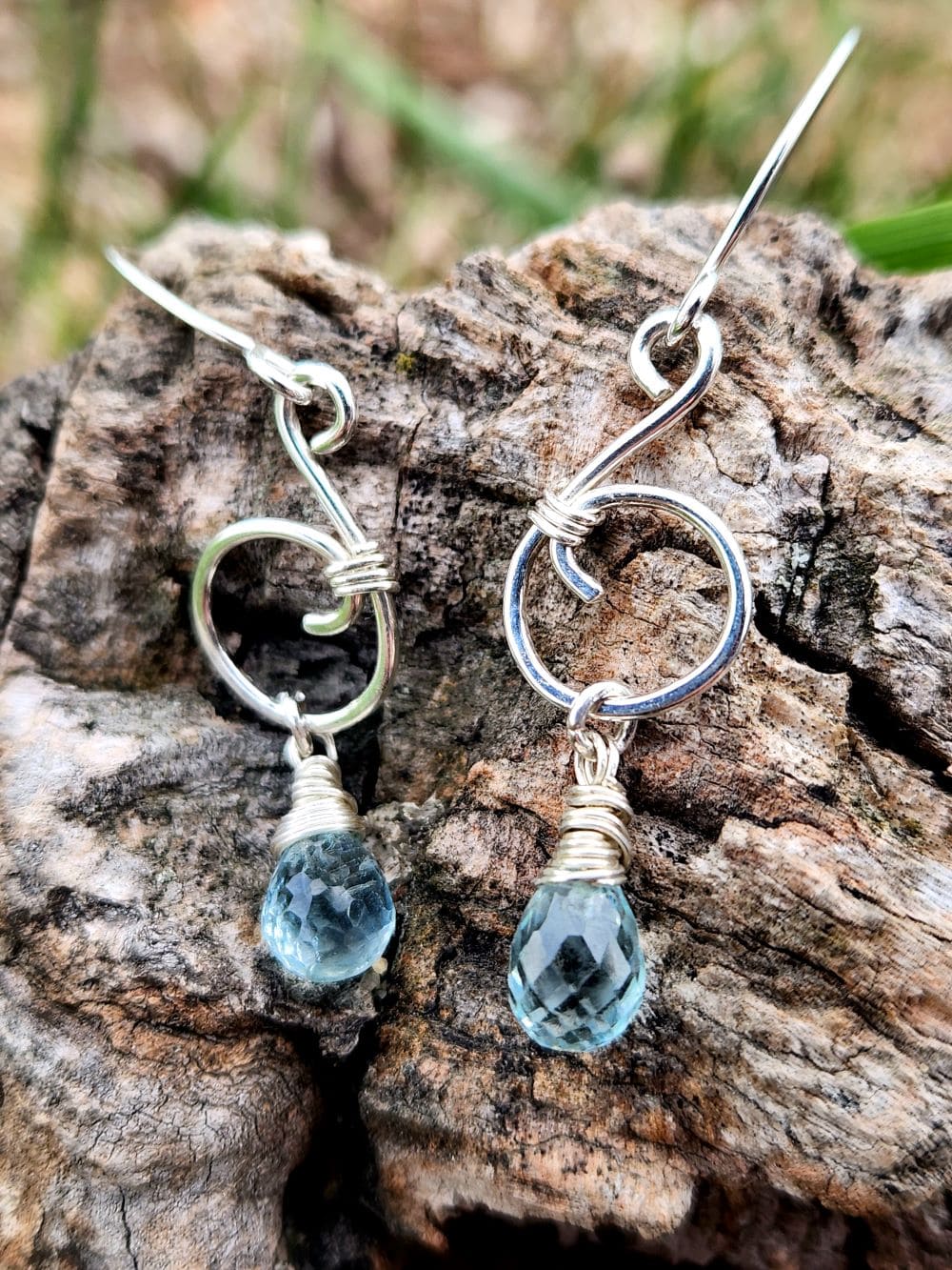 Handmade aquamarine music note earrings in sterling silver on wood