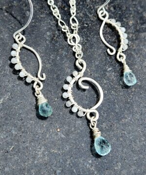 Handmade sterling silver aquamarine jewelry set on black surface