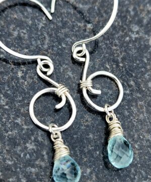 Handmade sterling silver ocean inspired jewelry on rock