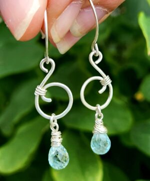Ocean inspired music note earrings featuring aquamarine gemstones and sterling silver in nature