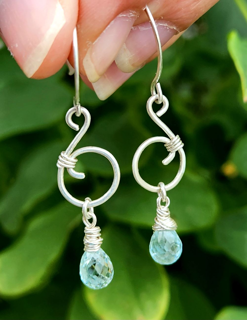 Ocean inspired music note earrings featuring aquamarine gemstones and sterling silver in nature