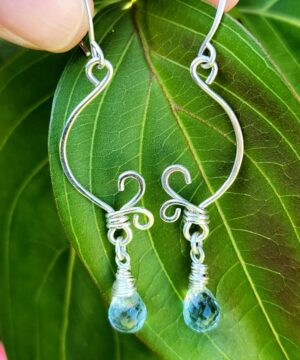 Nature-inspired sterling silver aquamarine wire-wrapped earrings on leaf