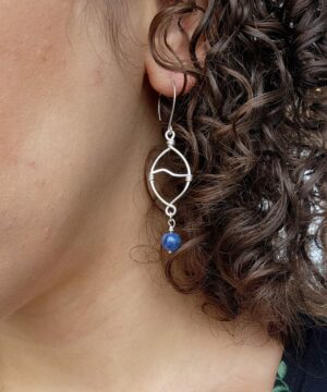 Sterling silver kyanite dangle earrings worn indoors