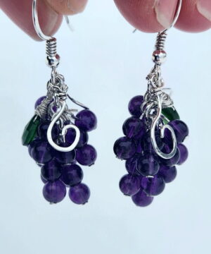 Handmade amethyst grape earrings in front of snow with chrome diopside gemstones