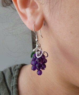 Wearing wire-wrapped sterling silver amethyst earrings indoors
