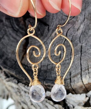 14k gold-filled heart-inspired earrings in front of tree