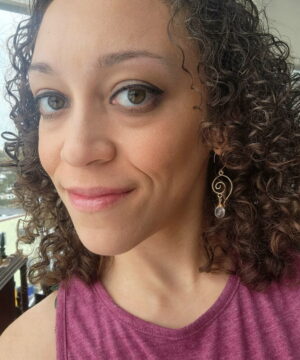 Wearing wire-wrapped 14k gold-filled rose quartz earrings indoors